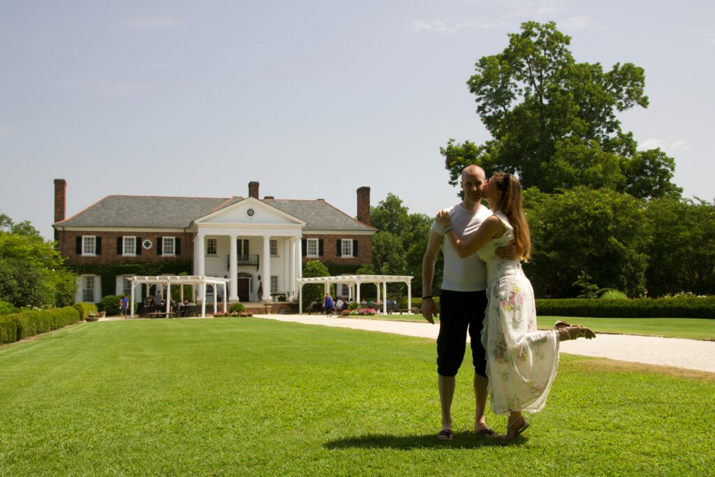 A couple shares a tender moment on the lawn of a historic mansion in Mount Pleasant, SC.